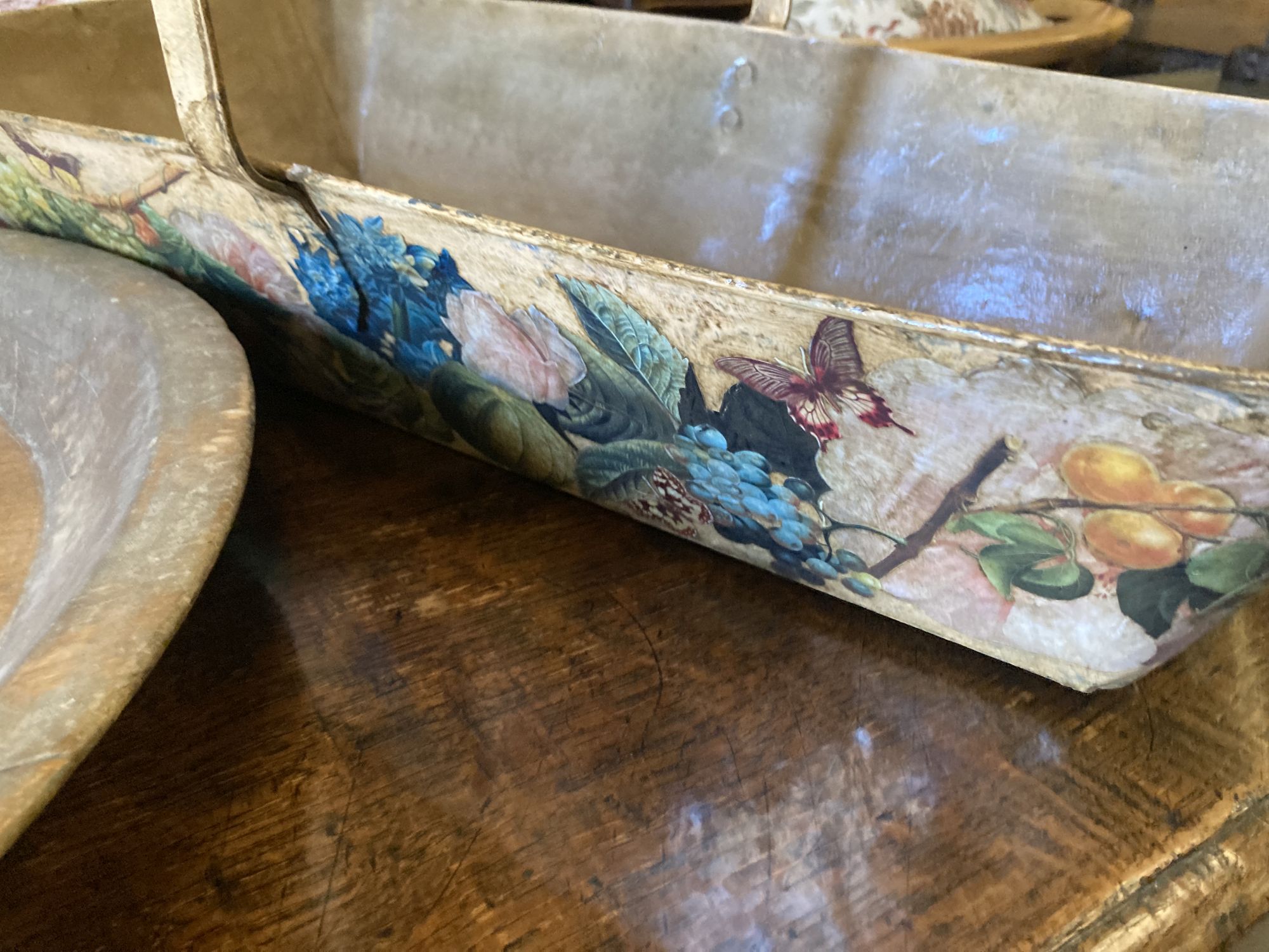 A circular treen shallow bowl and a painted toleware trug, width 69cm, depth 36cm, height 32cm